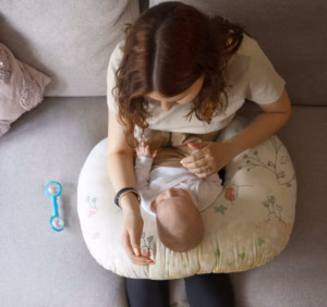 mama con cojín nido y bebé
